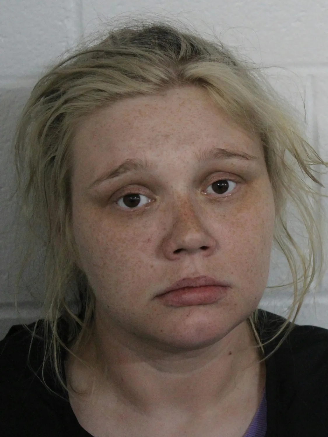 Whitney Purvis faces legal charges while mourning her 16-year-old son's unexplained death.
