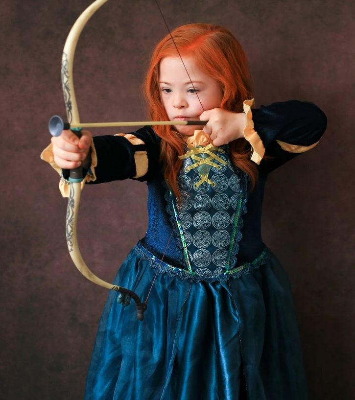 13. Chloe Lennon, at the age of 6, fearlessly embodies the adventurous spirit of Merida from Brave, showcasing bravery beyond her years.