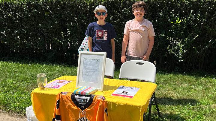 Danny Doherty set up an ice cream stand, with half the proceeds supporting his brother's special hockey team in Massachusetts.