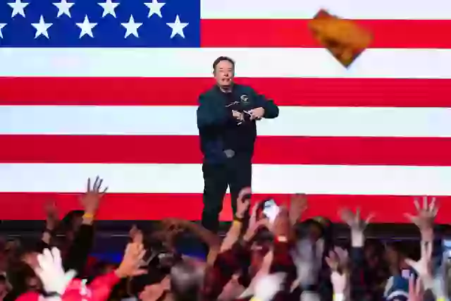 The billionaire signed the hat and tossed it into the crowd.